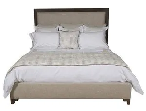 Louise King Bed with dark wood frame, upholstered warm neutral headboard and footboard, styled with white and beige bedding