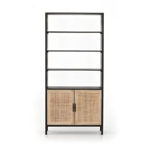 Blurred full view of tall bookshelf with natural cane doors and open shelves above
