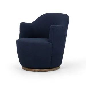 Round swivel accent chair upholstered in indigo boucle with drum-style seat and solid rubberwood base