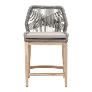 Loom Outdoor Woven Counter Stool with gray woven backrest and light beige cushion on teak wood frame