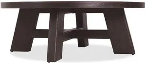 Round cocktail table in burnt timber finish with X-stretcher base and durable oak veneer construction