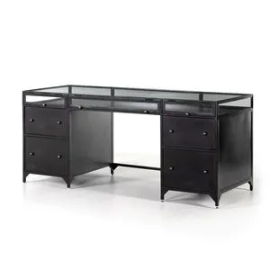 Shadow Box Executive Desk in black with matte metal frame, glass top and enclosure, brass knobs, and multiple drawers