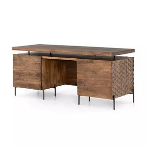 Raffael antique brown carved desk with 71-inch wide hardwood frame and intricate carved side panels, elevated on metal legs.