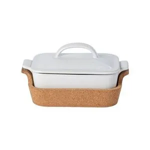 Small white oval ceramic stoneware casserole with lid, resting in a natural cork tray